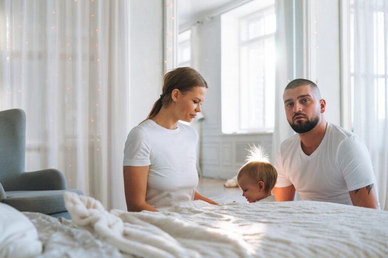 young family in bedroom with mother, father and daughter in natural light secondary infertility