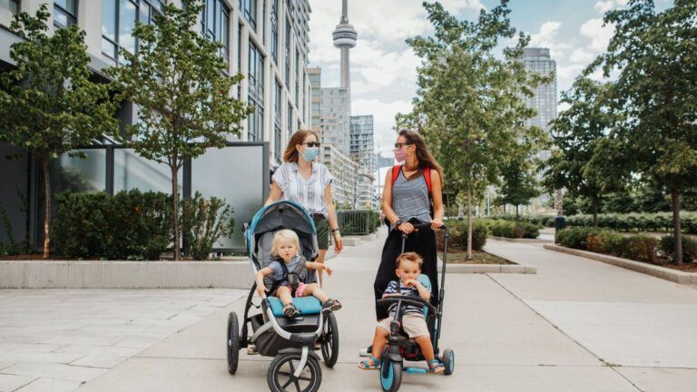 two women walking with strollers