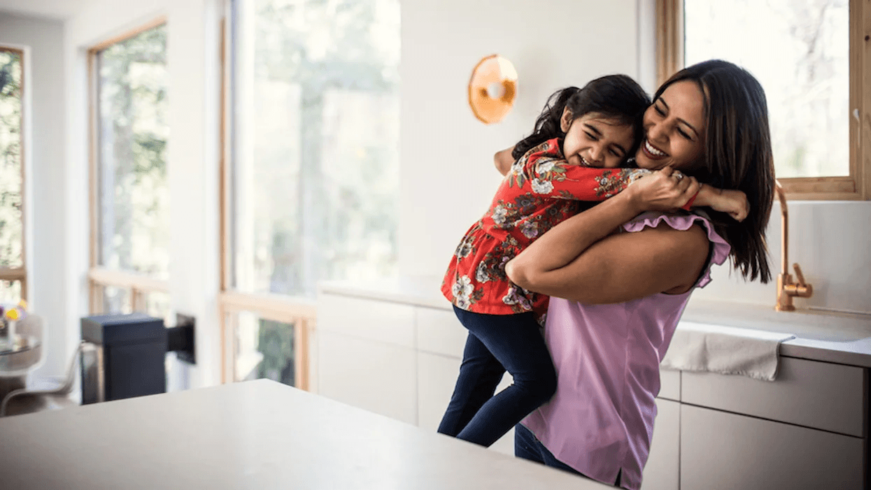 mom-picking-up-child-in-kitchen