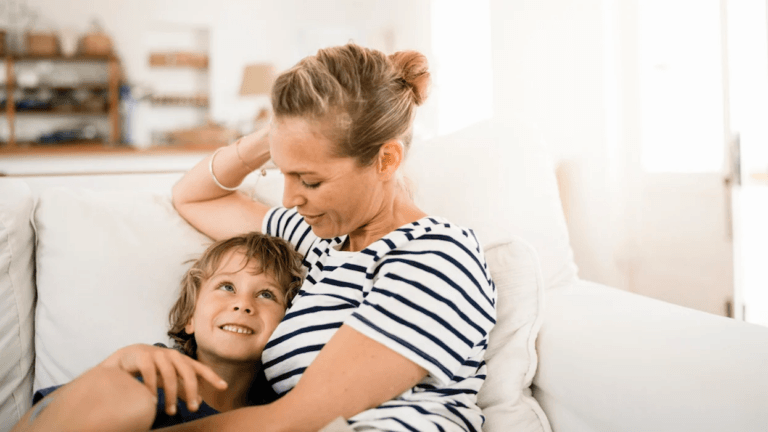 mom and son snuggling on the couch