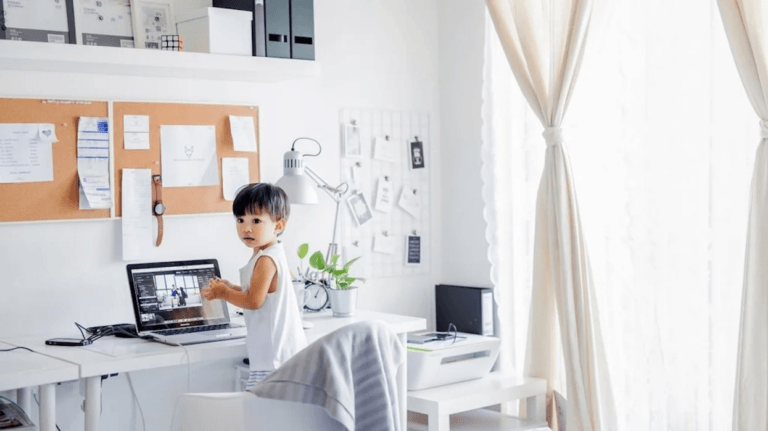 little kid playing on a computer