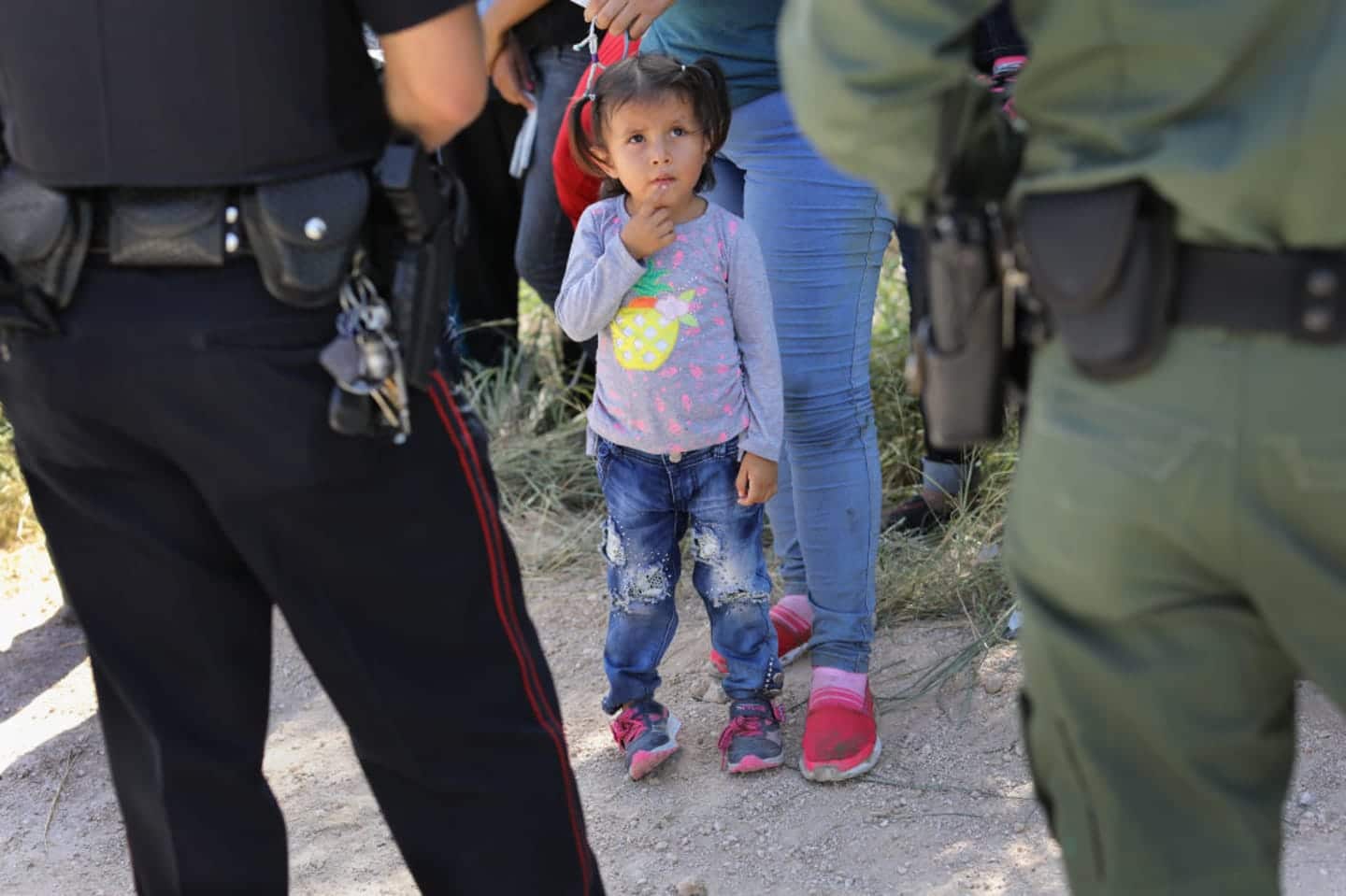 child looking at police officers