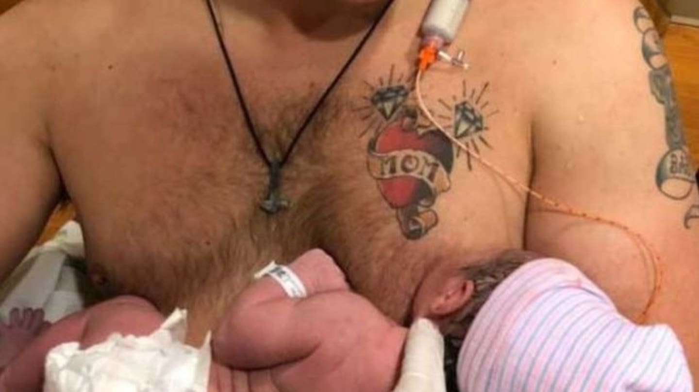 dad breastfeeding newborn daughter featured