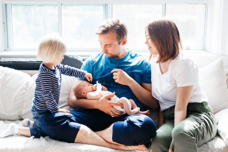 couple sitting on a couch with two kids