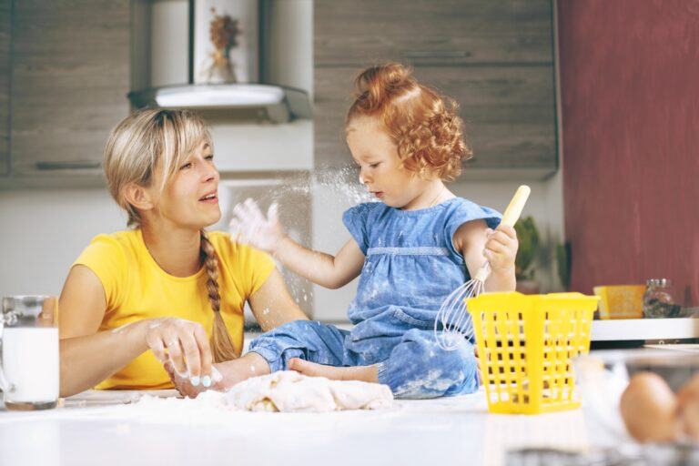 mom and daughter playing in the kitchen