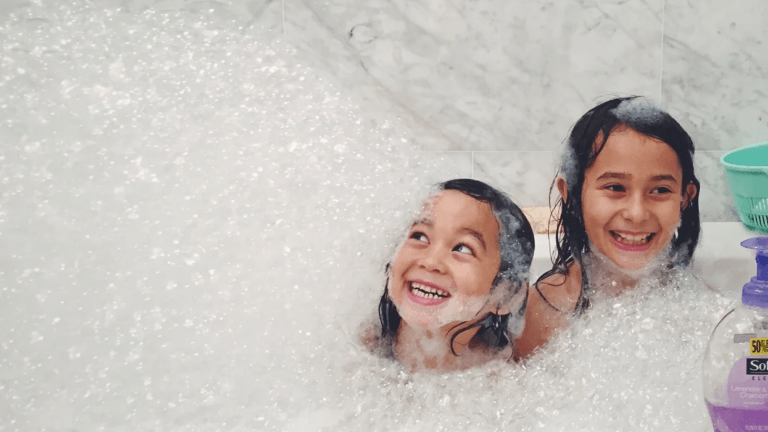 two little girls in a bubble bath