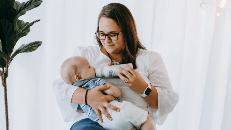 mom giving a baby a bottle