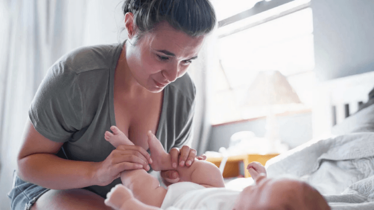 woman playing with baby legs