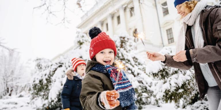 Kids with sparkler's outside in the winter - Noon Year's Eve