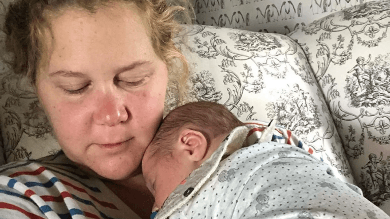 Amy Schumer holding her newborn son