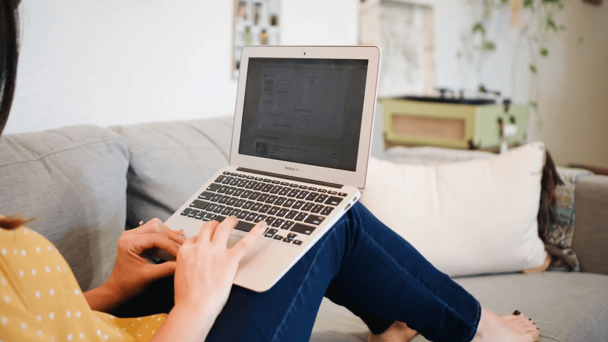 woman working on a laptop on the couch