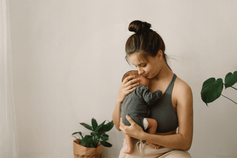 mom holding newborn baby to her chest