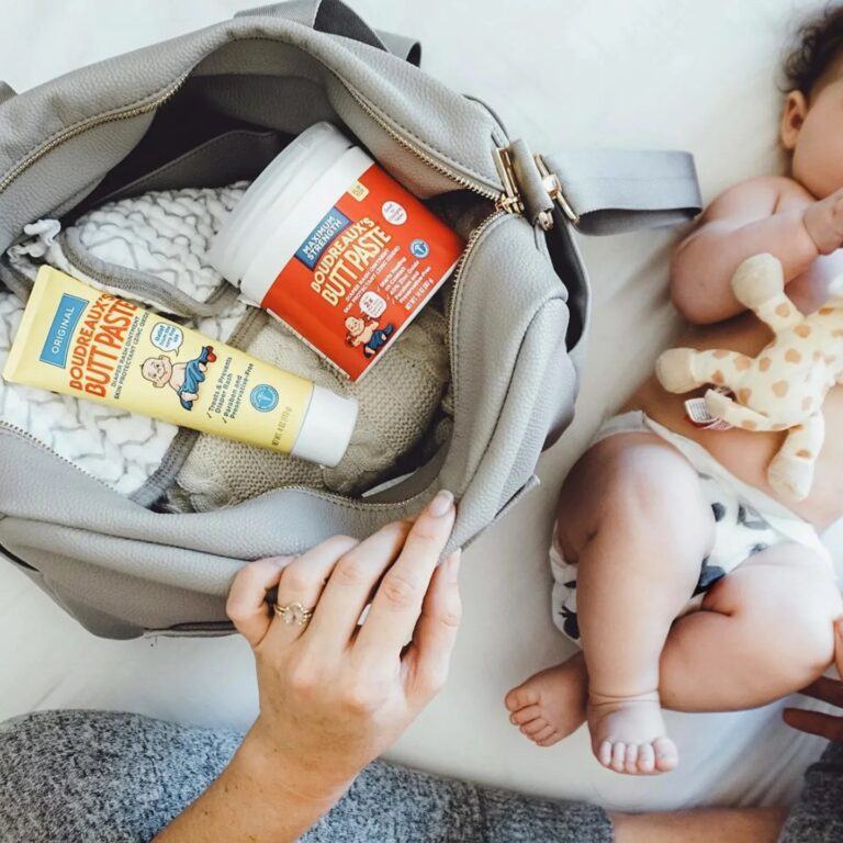 mom opening diaper bag to diaper cream