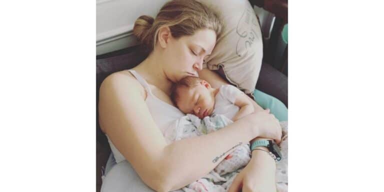 mom sleeping with her baby on her chest in a chair - essay on postpartum rage