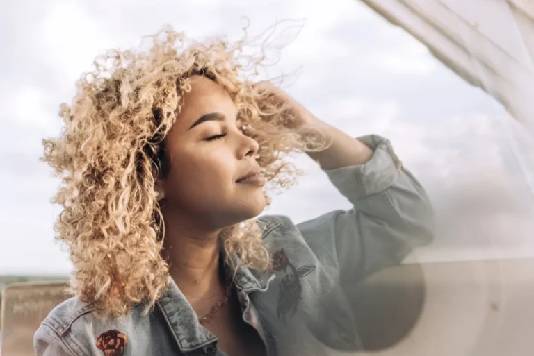 woman running her hands through her hair