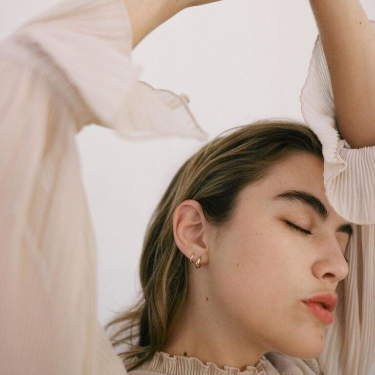 woman wearing gold hoop earrings