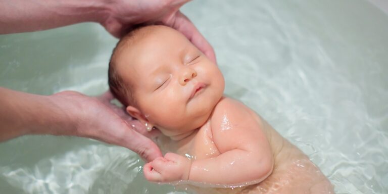 newborn baby being held in bathtub water acquarius names