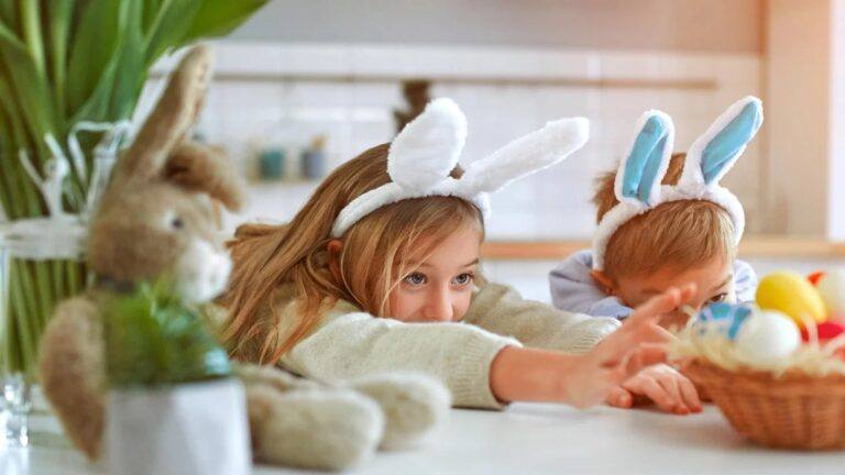 little boy adn little girl reaching for the easter baskets