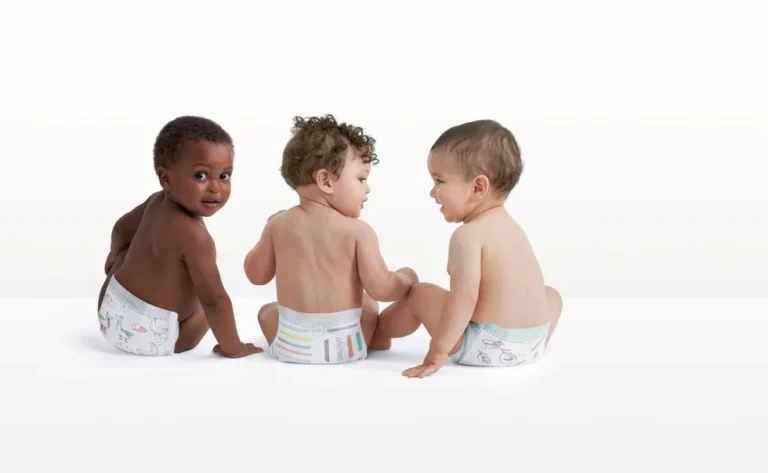 three babies wearing diapers in photography studio