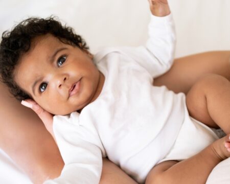 cute african american baby on mothers lap Motherly