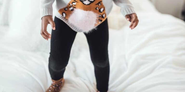 little-girl-jumping-on-the-bed