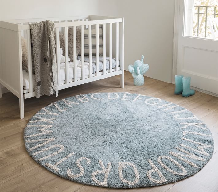 round blue rug on nursery floor