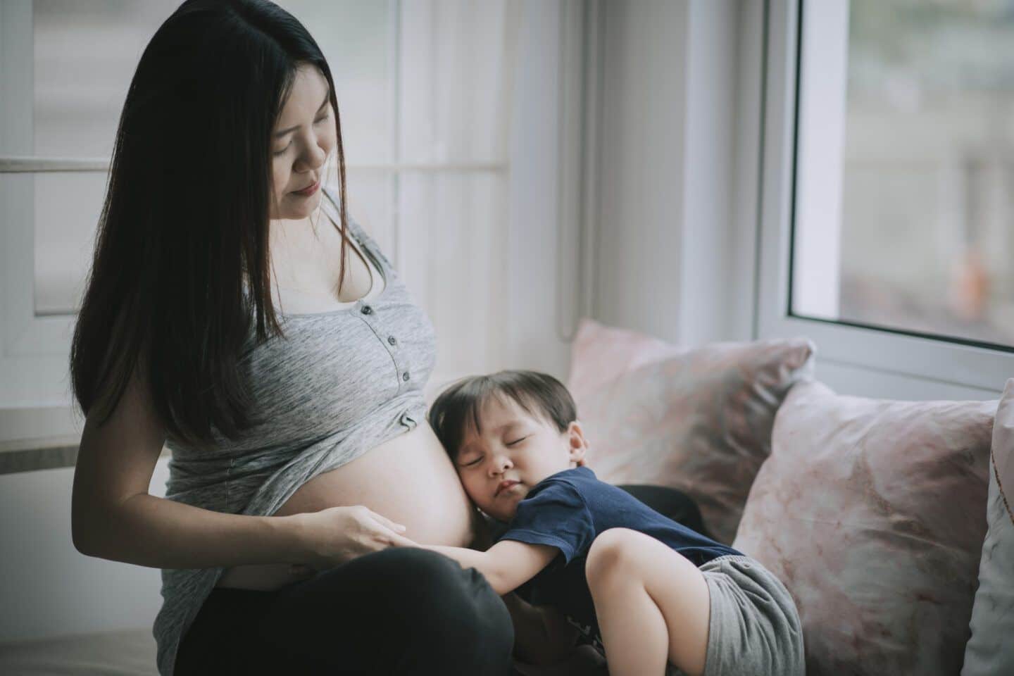 Premium Photo  Happy pregnant woman with big belly on colored background -  young woman wearing underwear expecting a baby - pregnancy, motherhood,  people and expectation concept 