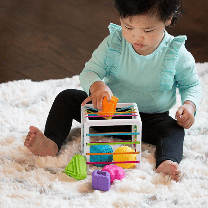 baby-playing-with-STEM-toy-on-rug