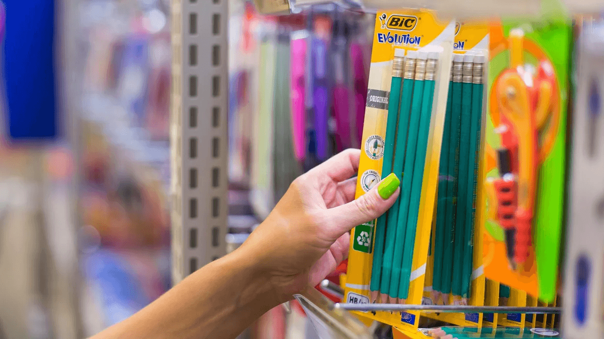 woman grabbing pencils at a store