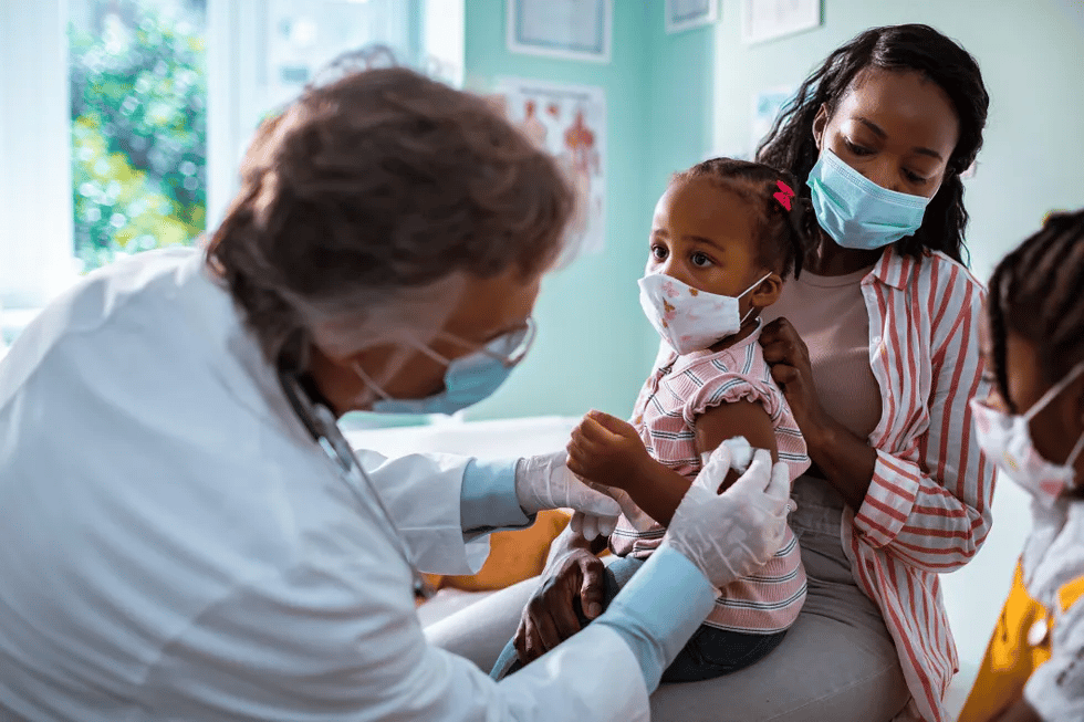 child-getting-vaccinated-at-pediatrician's-office