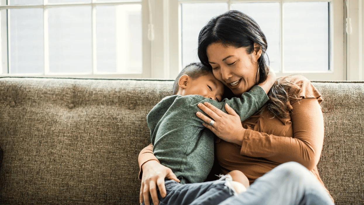 mom embracing child couch 1 Motherly