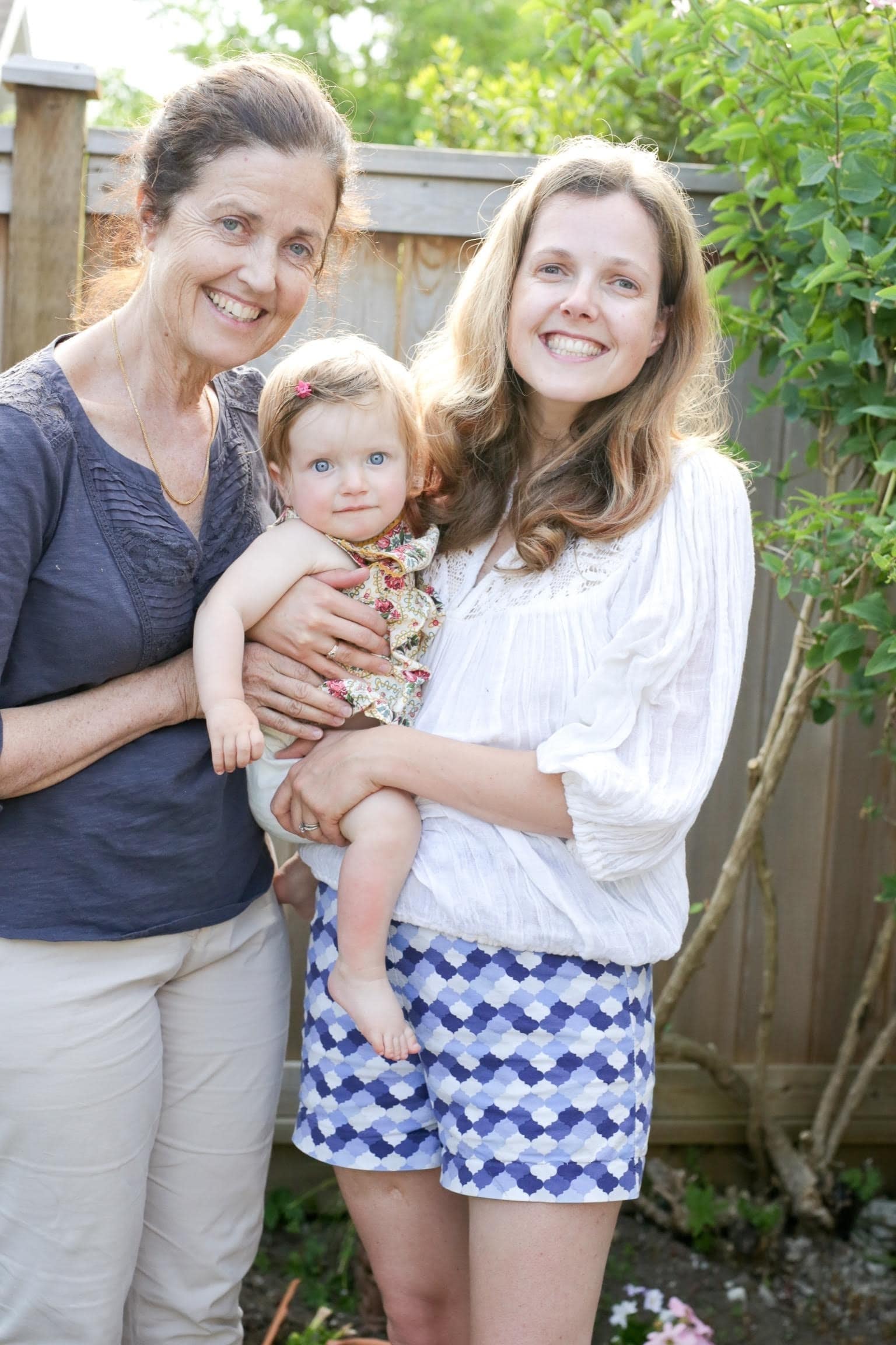 Two business women and moms posing with child