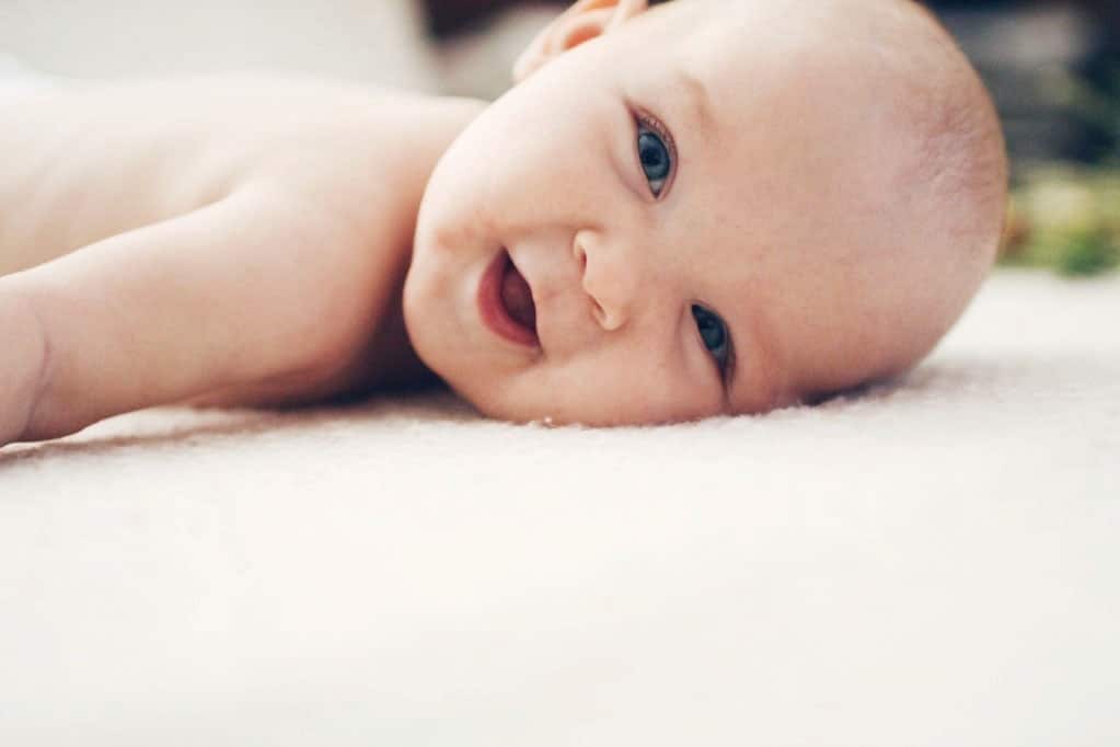 newborn baby laying on the floor