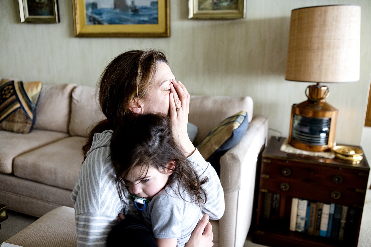 mom holding her son and crying