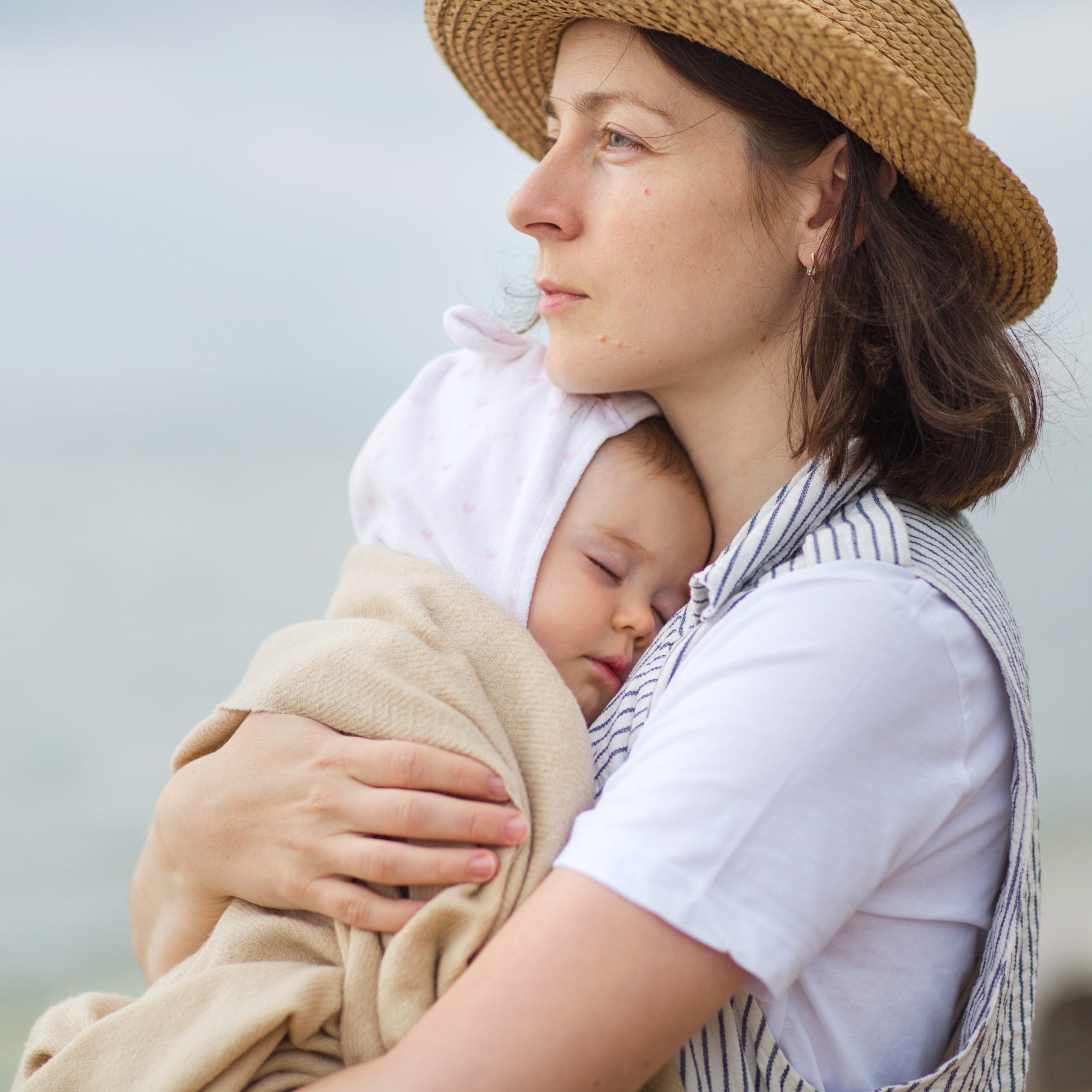 mom holding baby against her chest