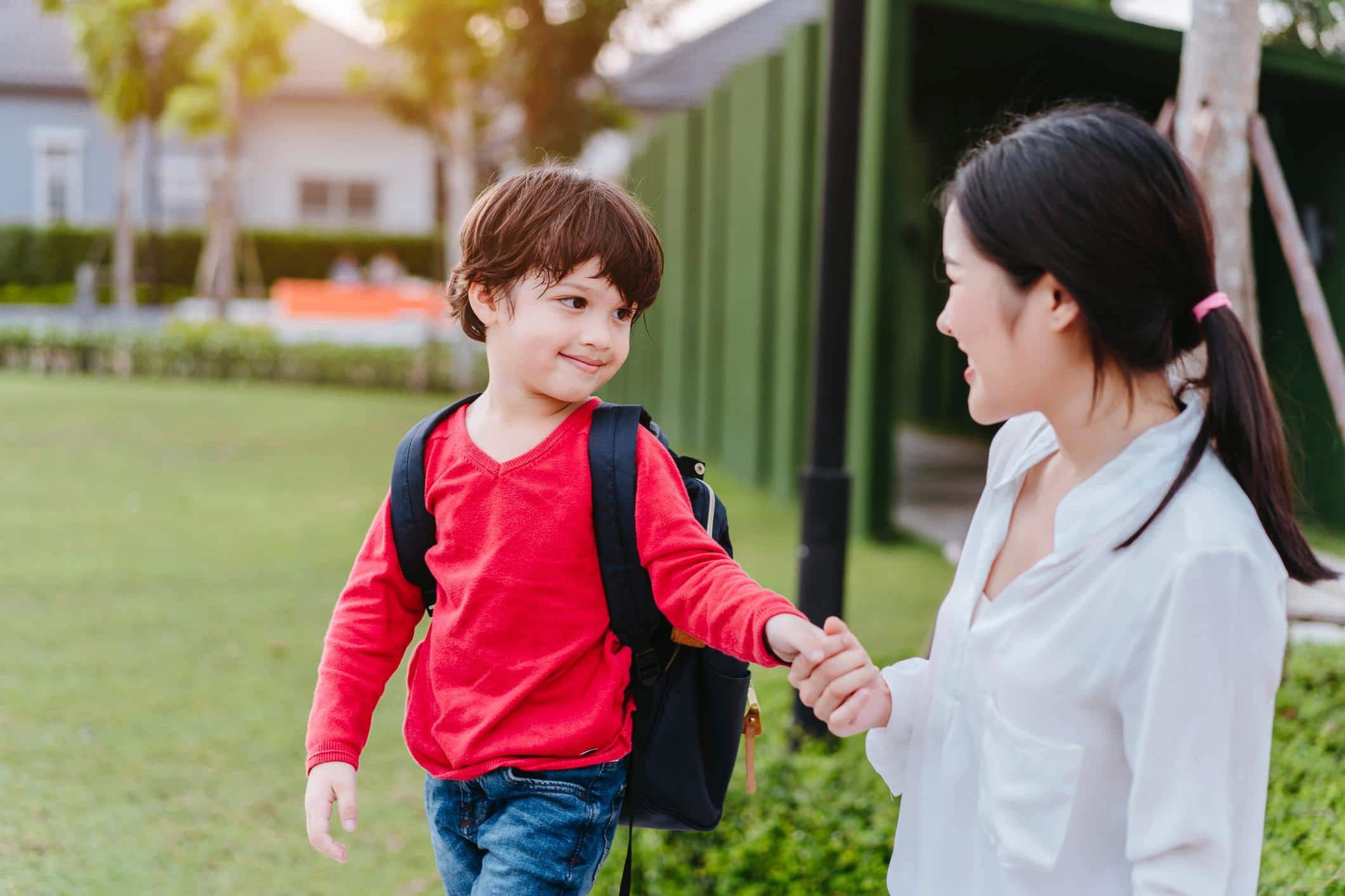 mom walking son into school