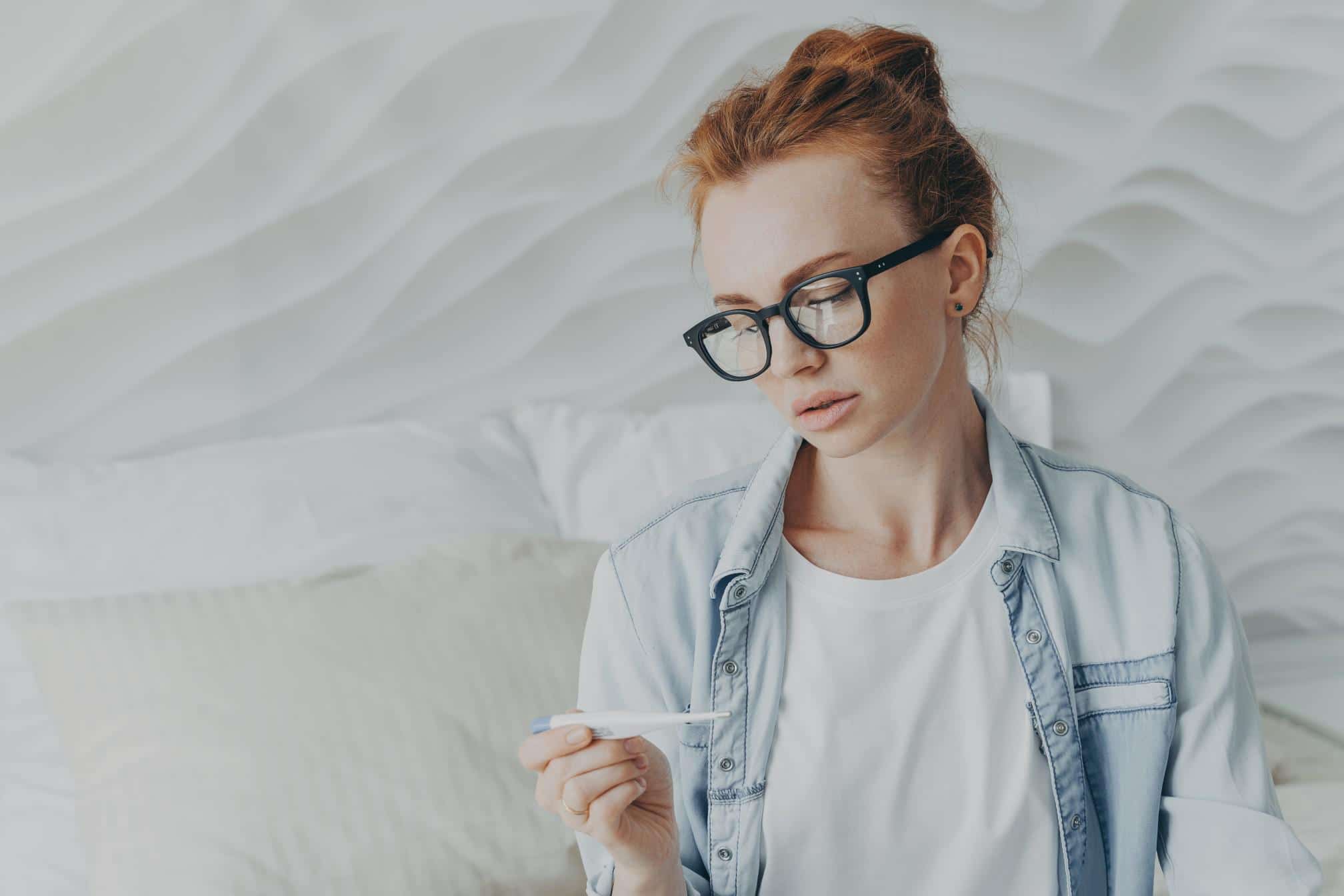 woman reading pregnancy test