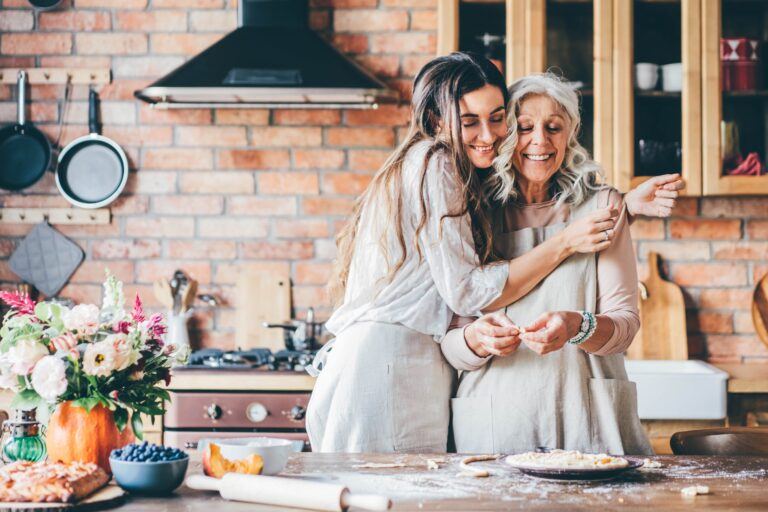 daughter hugging mother in the kitchen