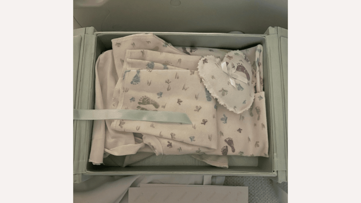 A memory box full of newborn clothes