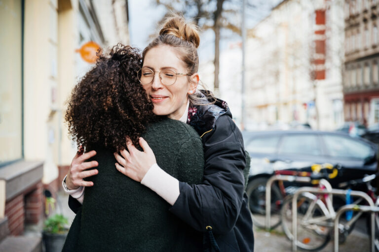 Need our friends: two women hugging