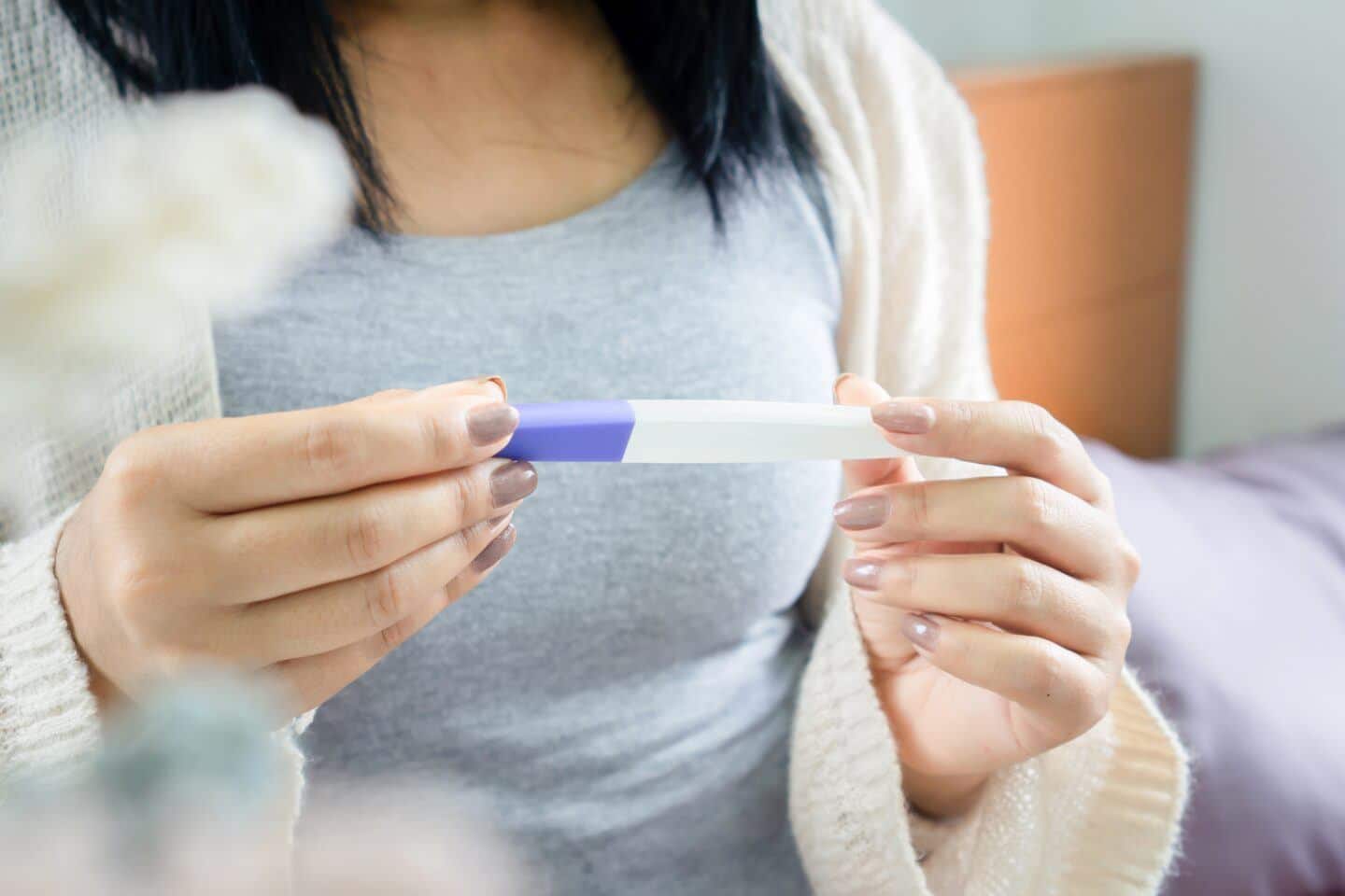 IVF struggles: closeup of woman holding pregnancy test