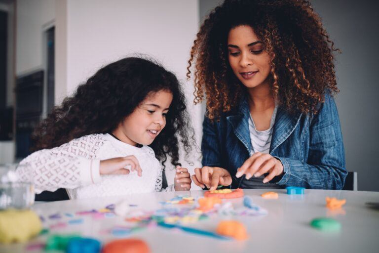 mom playing with daughter on a table