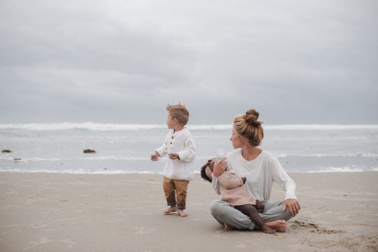 climate change: mother feeding daughter on the beach with toddler