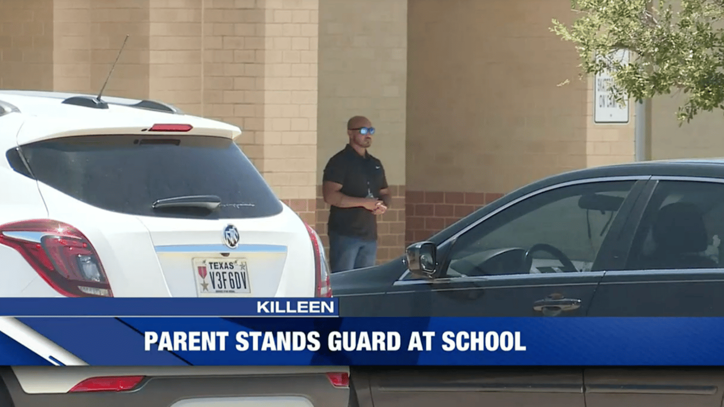 Texas dad standing guard outside child's school