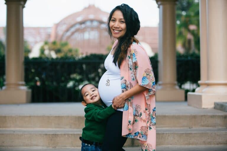 Toddler hugging moms pregnant belly