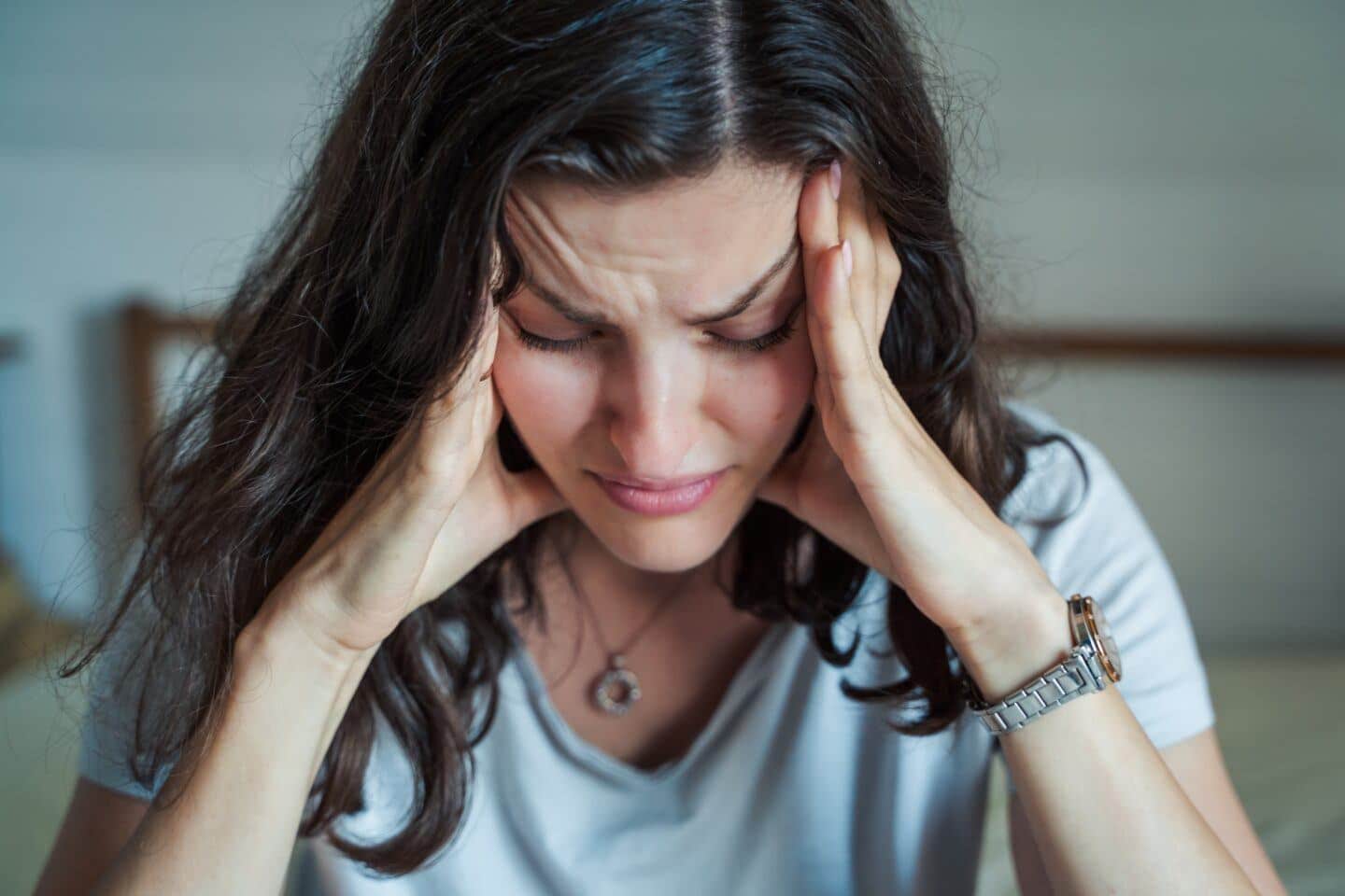 unhappy woman with her head in her hands