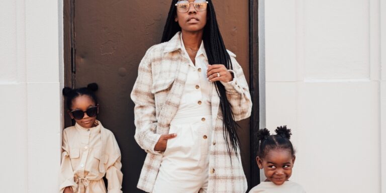 mom posing alongside two daughters - raising daughters