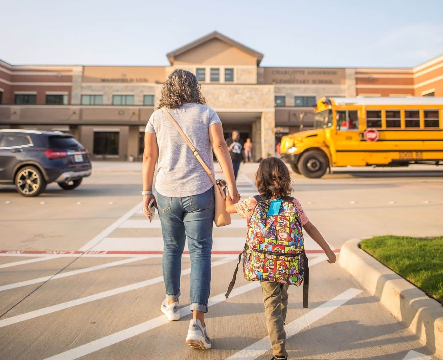 mom dropping daughter off at school- first day of kindergarten