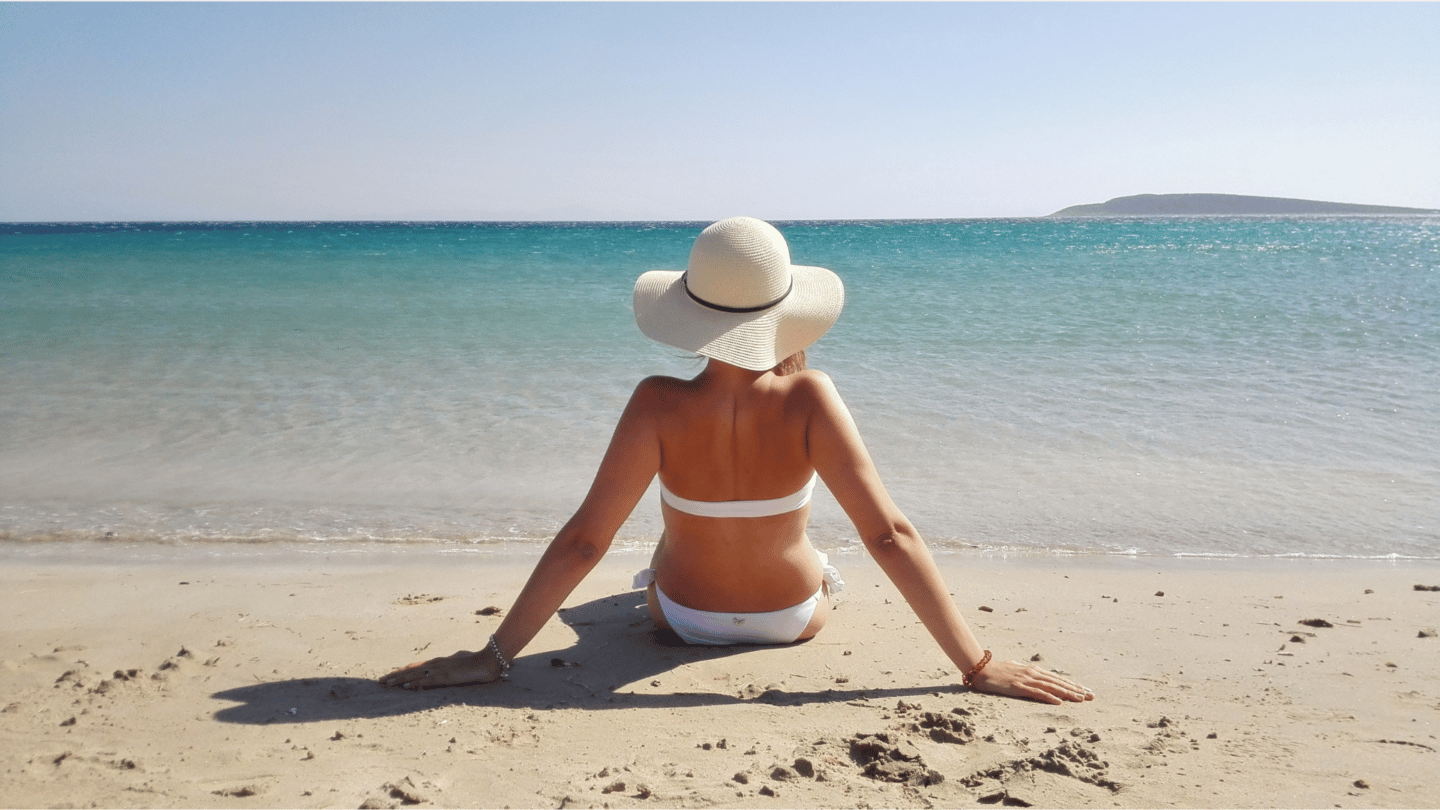 Men's straw beach hat on the sand at the beach, close-up, copy