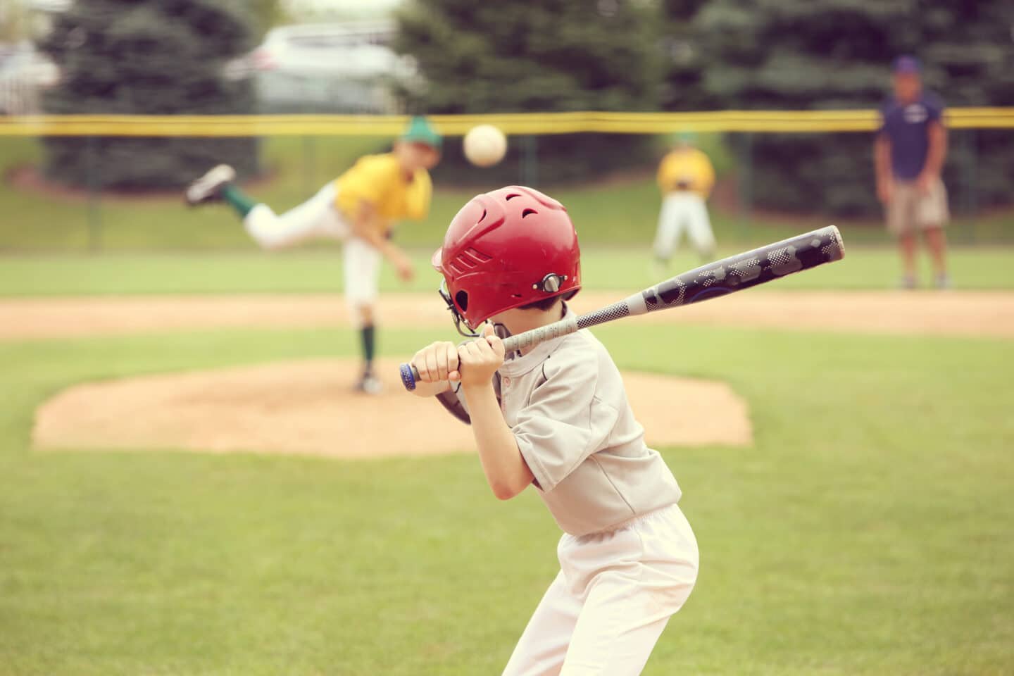 kid hitting baseball